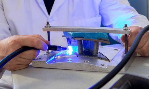 A technician performs an air flow test on a turbine.